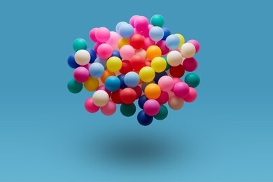 multi colored balls levitation in mid air on blue background. 