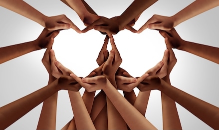 diversity love and unity partnership as heart hands in groups of diverse people connected together shaped as an inclusion and inclusive support symbol of teamwork and togetherness.