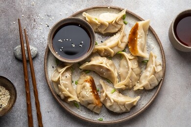 traditional japaneese gyoza dumplings with meat and mushrooms on ceramic plate,  top view