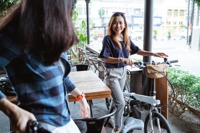 two young women cyclists meeting at the cafe to discuss the event during the holiday weekend