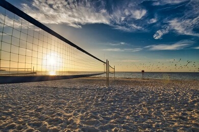 a volleyball court at north shore park in st. petersburg, fl as the sun is rising over tampa bay.