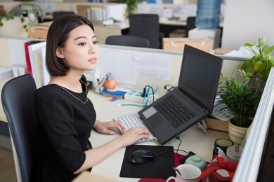 young beautiful girl, sitting in the office began her work