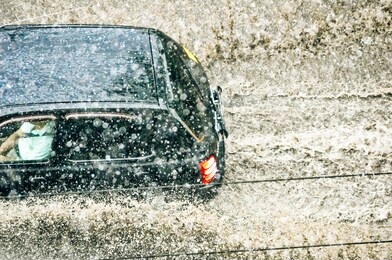 car splash through flood water after heavy rain