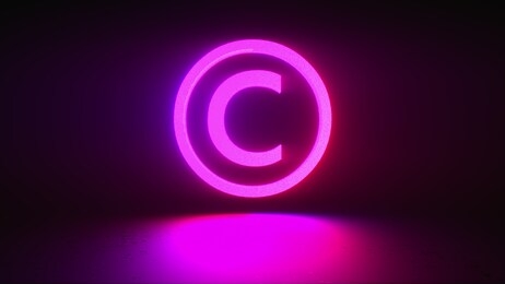 rotating neon copyright sign on a dark background, computer generated. 3d rendering of copyright protection