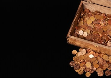 euro coins in chest on black backgrtound. view from top.