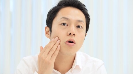 beauty concept of a young asian man. skin care.