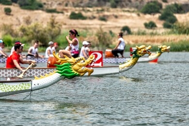 three dragon boats on the start line