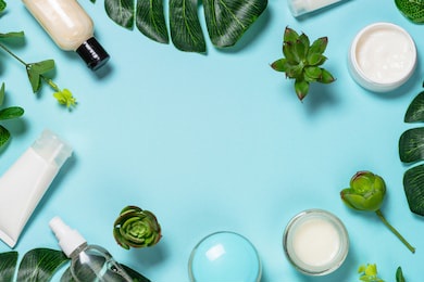 skin care product, coconut oil, natural cosmetic, flat lay image on blue background.