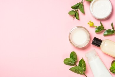 skin care product, natural cosmetic, flat lay image on pink background.