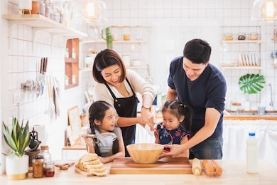 asian family enjoy playing and cooking food in kitchen at home