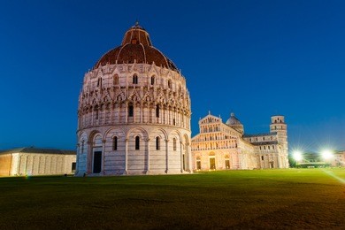 the baptistery of the cathedral in pisa at night, italy 