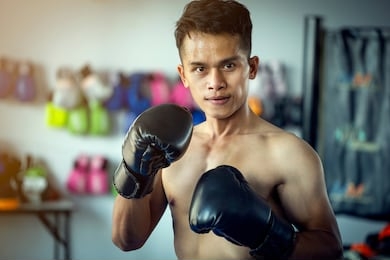 asian young man muay thai boxer in the gym, thai boxing
