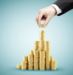 hand holding coins and build coin chart