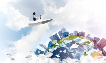 funny aviator sitting in paper plane and holding steering wheel. pilot driving paper plane in cloudy blue sky. spherical view of modern city with high skyscrapers in business district.