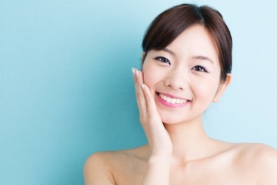 attractive asian woman skin care image isolated on blue background