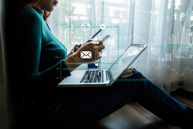 businesswoman holding credit card and using smartphone with laptop computer. online shopping concept. digital technology with virtual icon diagram.