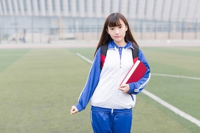 cute chinese female high school students on the campus playground learning