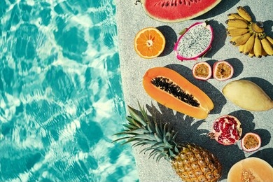 vacation and diet concept. tropical exotic colorful fruits near water in swimming pool.