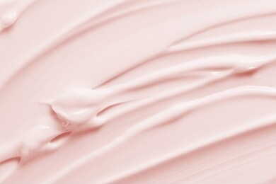 beauty cream texture background. pink color cosmetic cream lotion moisturizer smear. skincare product  strokes