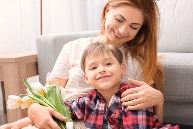 little boy greeting his mother at home