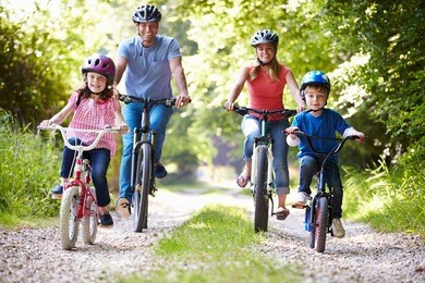 family on cycle ride in countryside