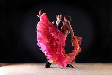 latino dancers in ballroom isolated on black background