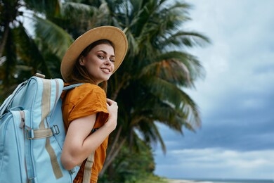 cheerful pretty woman in traveler backpack nature walk vacation tropics