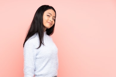 teenager chinese woman isolated on pink background . portrait