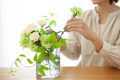 woman arranging flowers in a vase
