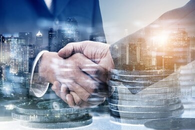 double exposure of businessman standing with stack of coins and city night background, money or revenue of saving and invest concept