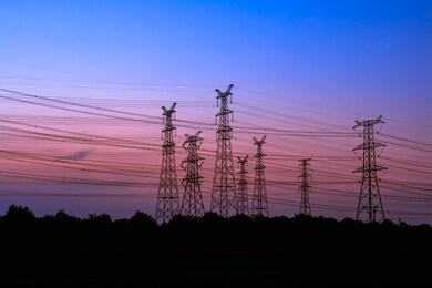 high voltage power tower and beautiful nature landscape at sunset