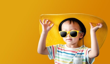 portrait kids with yellow background summer concept is coming.cute asian boys 3 years old.