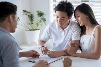 concept of real estate trading, the customer is signing a contract to buy real estate.