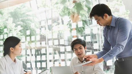 asian business adviser meeting to analyze and discuss the situation on the financial report in the meeting room.investment consultant,financial consultant,financial advisor and accounting concept

