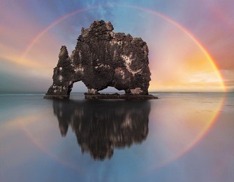 rainbow over ocean rock, iceland