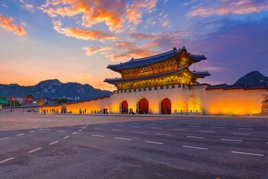sunset over gwanghwamun gate, seoul, south korea. ( sign board text is " gwanghwamun gate")