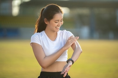 woman runners apply sunscreen lotion before running.