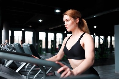 slender woman training on a fitness simulator