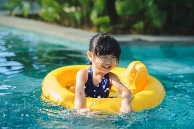 asian girl/kid having fun in swimming pool