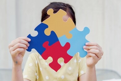 kid girl hands holding puzzle jigsaw,  mental health concept, autism spectrum, disorder, world autism awareness day