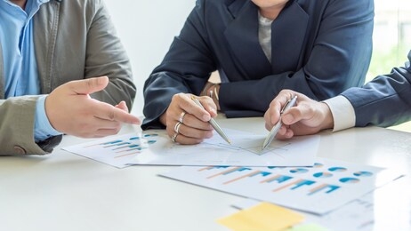 businessman pointing to a document graph during a business meeting.