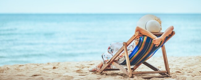 summer travel beach vacation concept, traveler asian woman with hat and dress relax on chair beach at pattaya, chon buri, thailand
