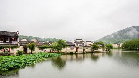raining days in hongcun. it's an ancient village near huangshan, world heritage site by unesco, has many wonderful traditional chinese architectures and carvings, red lanterns along the central lake.