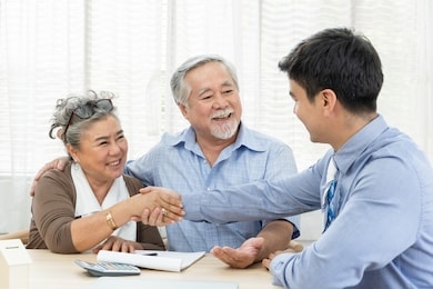 happy smiling asian old couple making purchase and mature woman handshake with real estate agent, sales man closing deal from business agreement contract, concept for retirement or lifestyle insurance