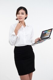 make-up artist asian girl shows the products of cosmetics, which was made makeup isolated on white background. the concept of beauty