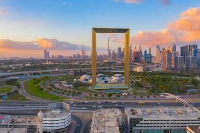 aerial view of dubai frame, downtown skyline, united arab emirates or uae. financial district and business area in smart urban city. skyscraper and high-rise buildings at sunset.