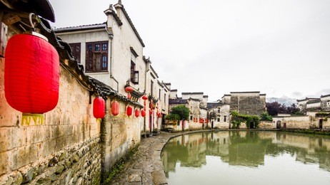 raining days in hongcun. it's an ancient village near huangshan, world heritage site by unesco, has many wonderful traditional chinese architectures and carvings, red lanterns along the central lake.