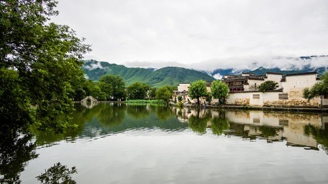 raining days in hongcun. it's an ancient village near huangshan, world heritage site by unesco, has many wonderful traditional chinese architectures and carvings, red lanterns along the central lake.