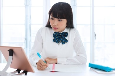 a female student wearing a uniform to study