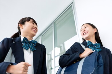 female students talking while walking